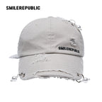White Distressed Baseball Cap with Pearl Charm Accents, Logo Embroidery and Adjustable Strap