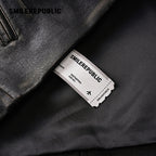 Brown Distressed PU Coated Faux Leather Oversized Asymmetrical Zip Jacket with Logo Back